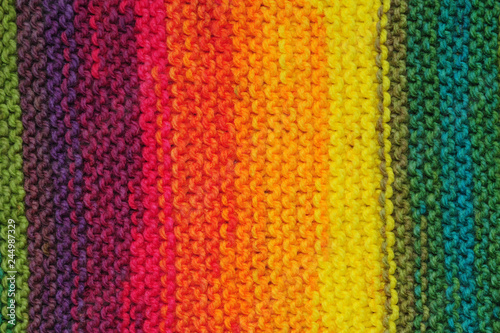 Handmade rainbow colored seamless knitted patterns texture with vertical rows
