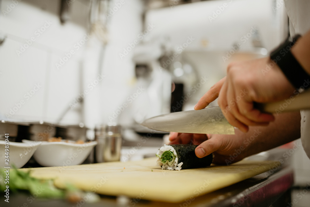 A close up shot of a chef making sushi. Concept of Japanese cultural cuisine, food and hospitality.