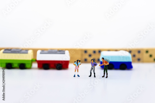 miniature people, backpack waiting bus at bus station for travel. using as business background concept.
