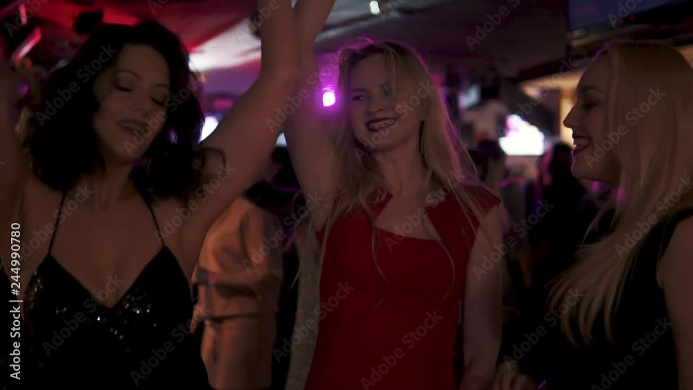 a group of friends dancing and having fun at a concert a group of friends dancing and having fun at a concert