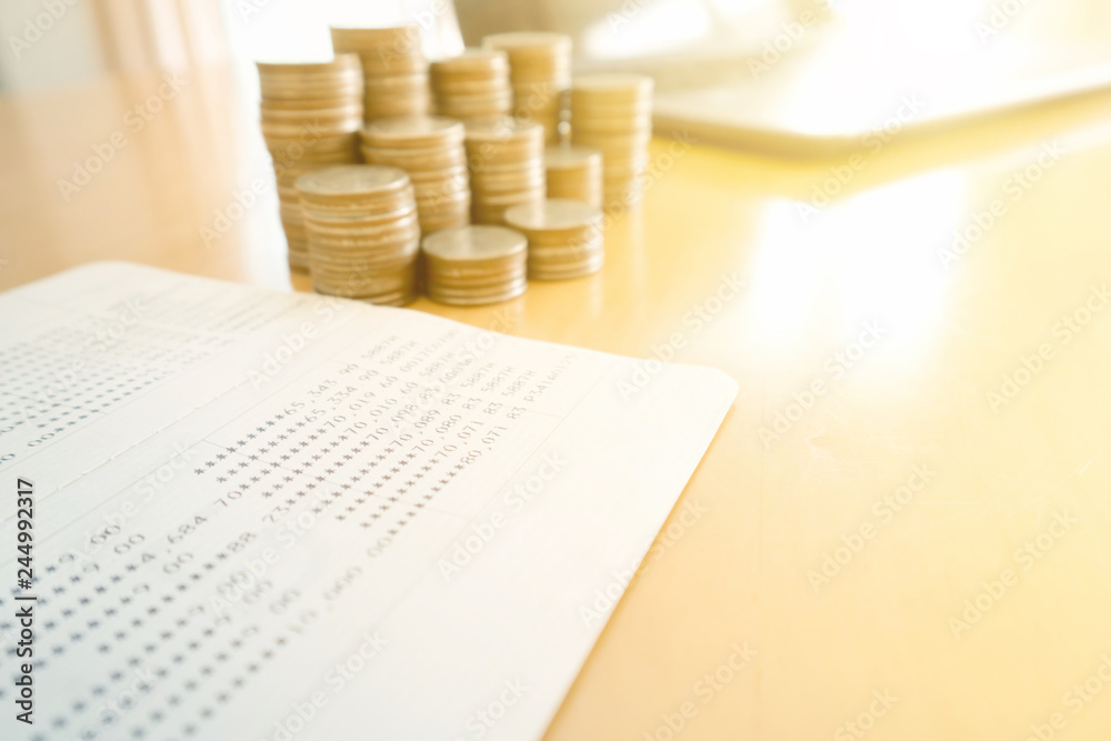 Obraz premium Coin stacks and savings account passbook