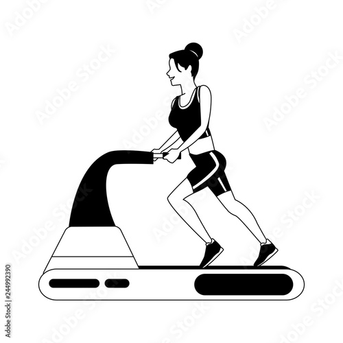 Fitness woman running on machine in black and white