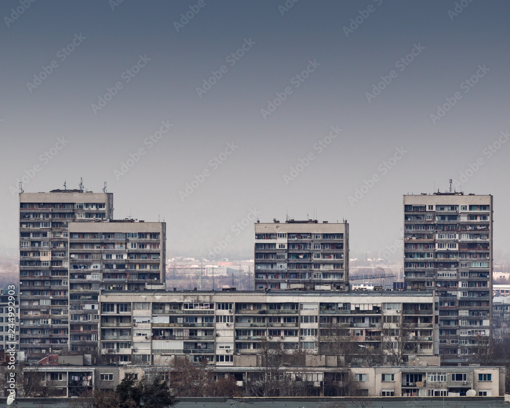 A group of concrete housing buildings in a city