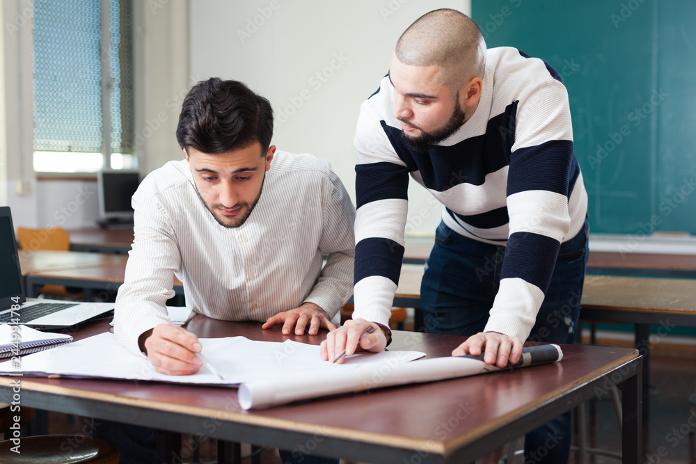 Naklejka premium Students preparing for exams in classroom