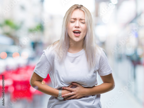 Young blonde woman over isolated background with hand on stomach because indigestion, painful illness feeling unwell. Ache concept. Free Download Young blonde woman over isolated background with hand on stomach because indigestion, painful illness feeling unwell. Ache concept. - GFXLoad