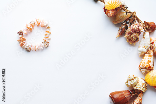 a necklace of pink shells in the shape of a heart.shell frame on white background.with copy space