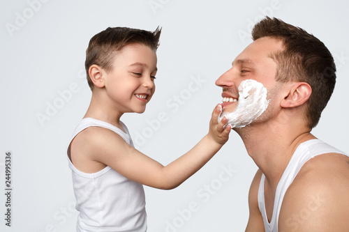 Son helping father with shaving