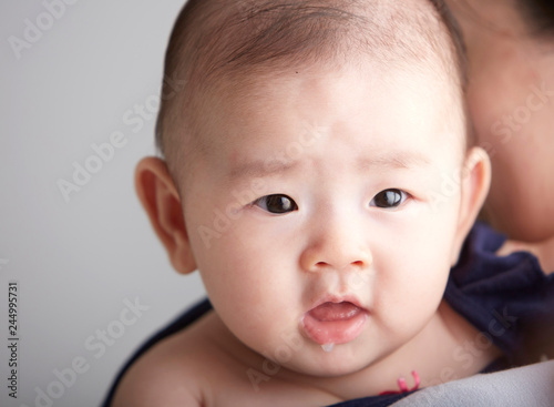 Closeup Asian baby leaning on mother s shoulder