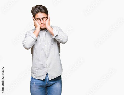 Young handsome man wearing glasses over isolated background with hand on head for pain in head because stress. Suffering migraine.