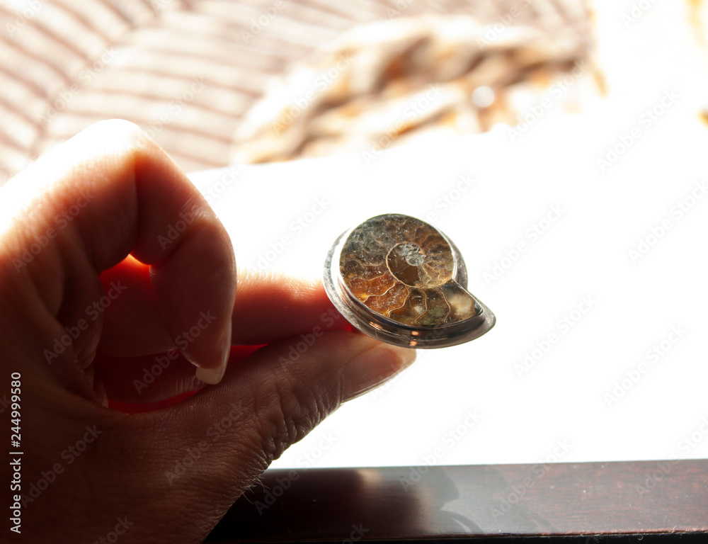 Fototapeta premium Modern design of ammonite precious stone ring in calcite extracted in Mexico