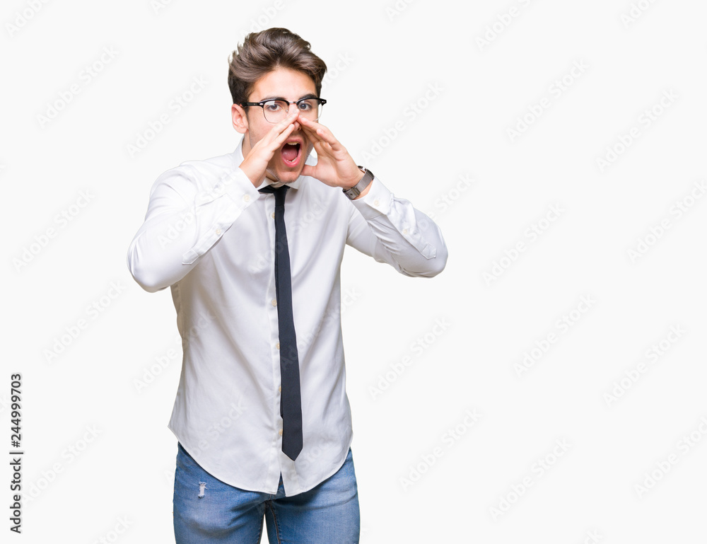 Young business man wearing glasses over isolated background Shouting angry out loud with hands over mouth Young business man wearing glasses over isolated background Shouting angry out loud with hands over mouth