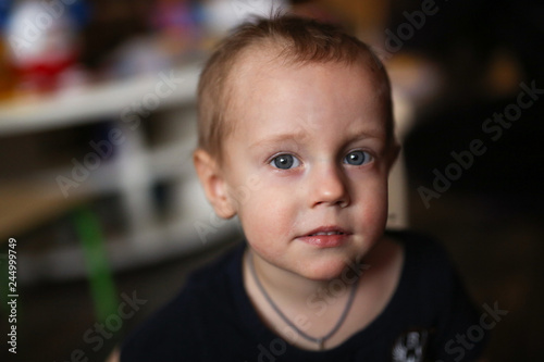smiling Toddler boy, closeup portrait on dark
