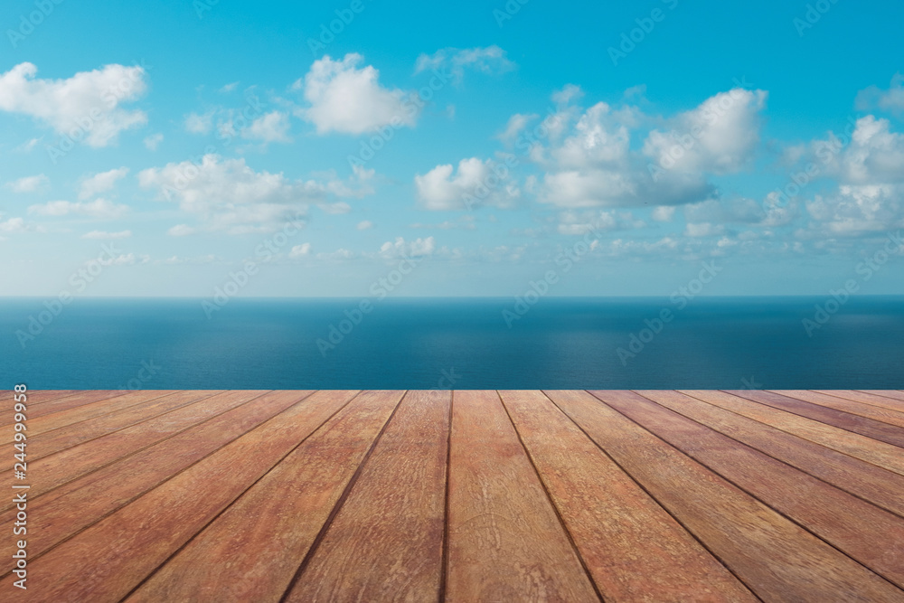 wooden board floor with ocean  and blue sky background  -