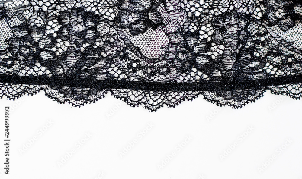 Black lace texture with flowers on a white background.Background