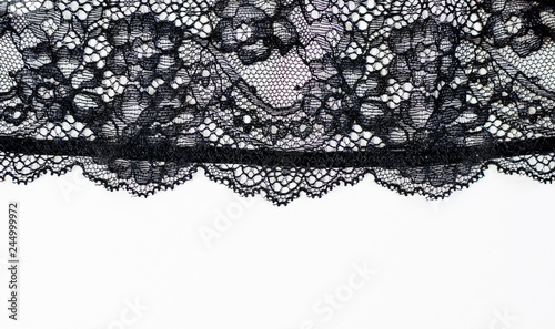 Black lace texture with flowers on a white background.Background of black lace with a flower pattern on a white background. Black guipure. Black fabric with an ornament. 