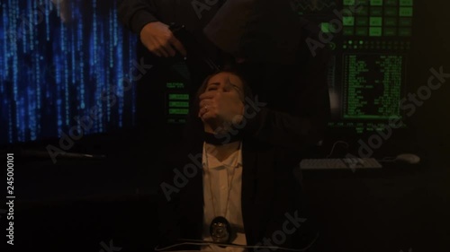 Terrorist threatening female police agent in handcuffs held hostage medium shot