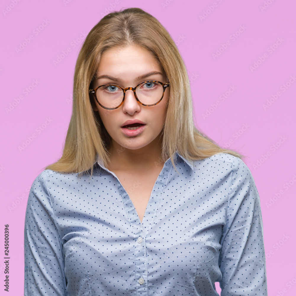 Young caucasian business woman wearing glasses over isolated background afraid and shocked with surprise expression, fear and excited face.
