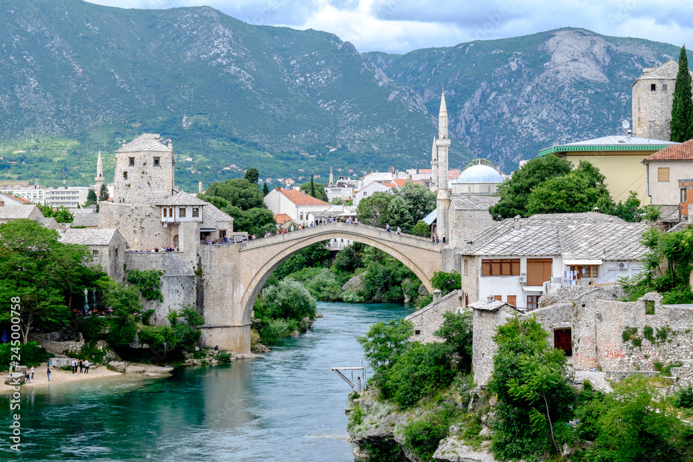The majestic ancient Stari Most bridge proudly spans the Neretva river, connecting the two halves of the city of Mostar for centuries.