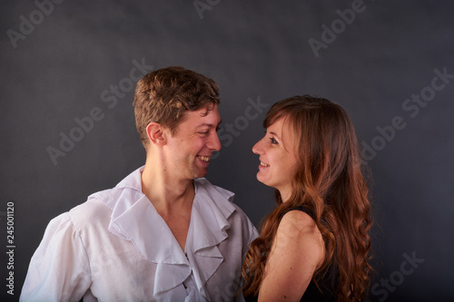 a couple in love stands on a dark background