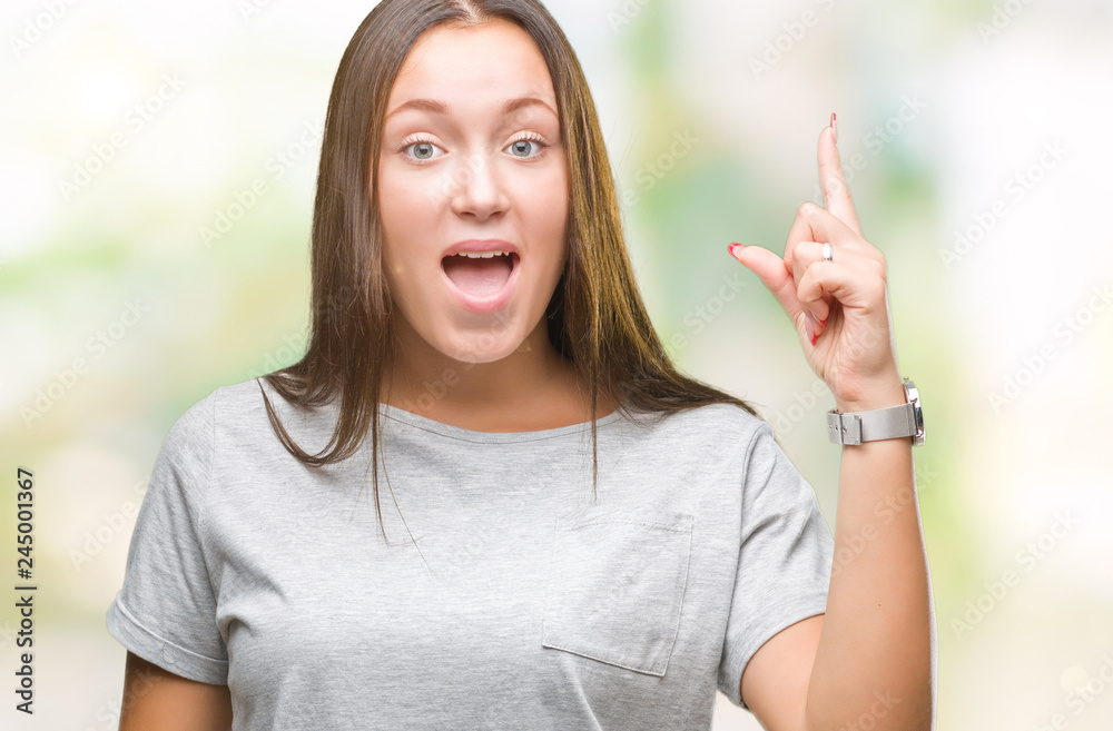 Young caucasian beautiful woman over isolated background pointing finger up with successful idea. Exited and happy. Number one. Young caucasian beautiful woman over isolated background pointing finger up with successful idea. Exited and happy. Number one.
