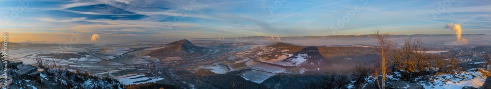 Panorama view of sunrise on Boren hill near Bilina town in winter frosty morning