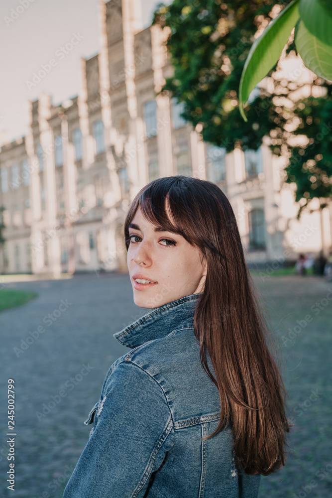 Young cute girl walking in city park Young cute girl walking in city park