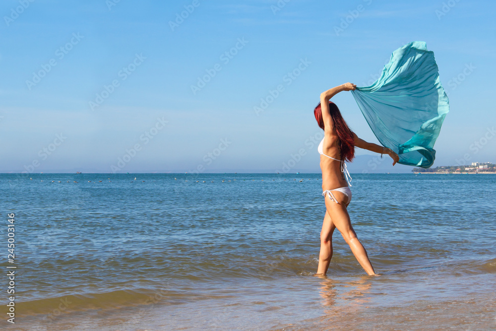 Woman walks on the beach