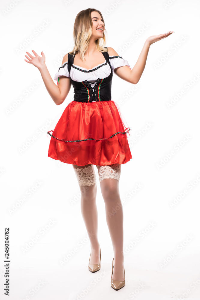 Full height of Bavarian girl in dirndl isolated over white background Full height of Bavarian girl in dirndl isolated over white background