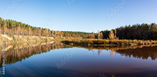 blue sky and clouds reflecting in calm water of river Gauja in latvia in autumn © Martins Vanags