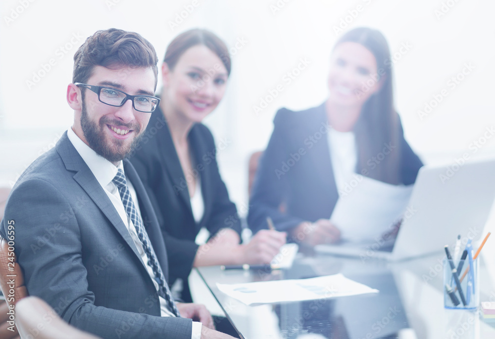 Fototapeta premium employees sitting behind a Desk.