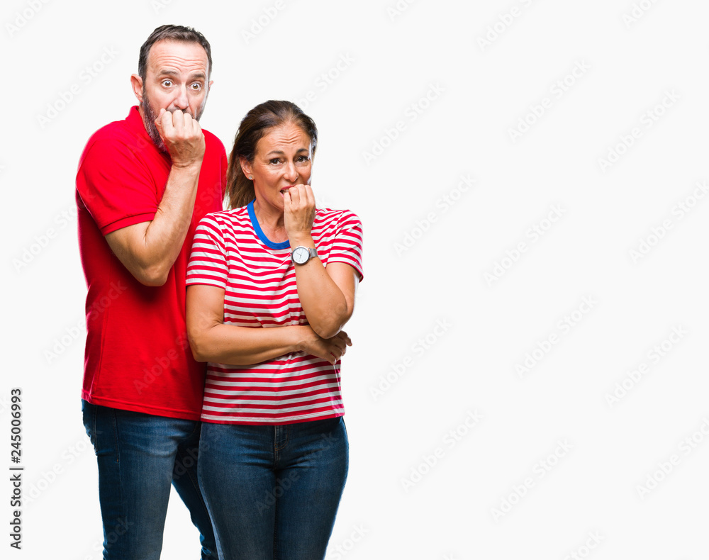 Middle age hispanic couple in love over isolated background looking stressed and nervous with hands on mouth biting nails. Anxiety problem. Middle age hispanic couple in love over isolated background looking stressed and nervous with hands on mouth biting nails. Anxiety problem.