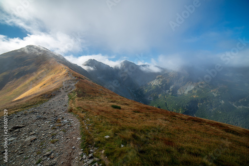Fototapeta Naklejka Na Ścianę i Meble -  walking above clouds in slovakian Tatra mountains