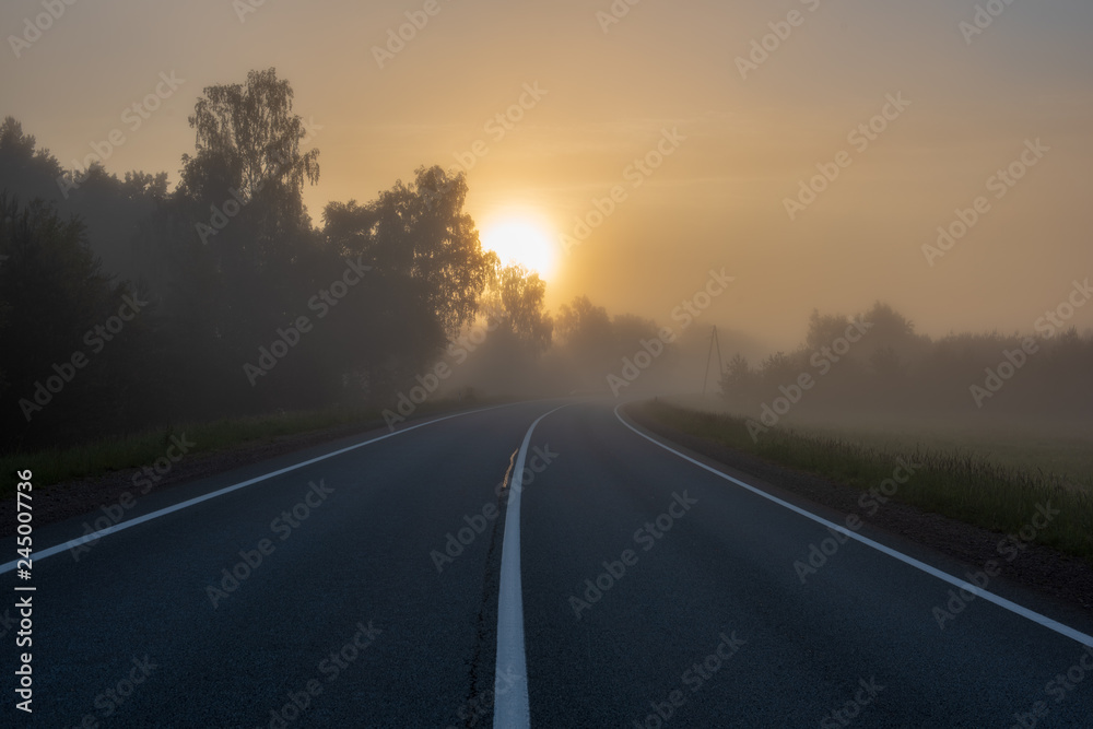 empty asphalt road with white lines painted in misty morning empty asphalt road with white lines painted in misty morning