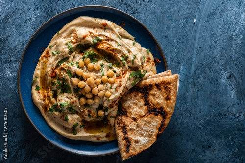 Classic Hummus with chickpeas, paprika, olive oil and oriental spices. Mediterranean popular snack of chickpeas and tahini pasta photo