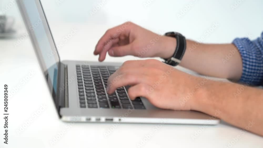 A man typing on computer, fingers typing on keyboard A man typing on computer, fingers typing on keyboard