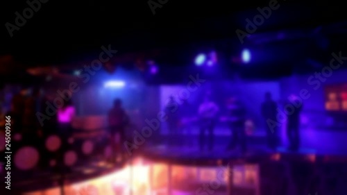 Sexy hot beautiful Go Go dancer in bikini Blurry night club dj party people enjoy of music dancing sound with colorful light. club night light dj party . With Smoke Machine