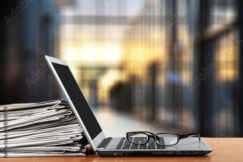 Laptop and black glasses  on   background. photo