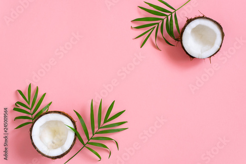 Pink tropical background with coconut and palm leaves