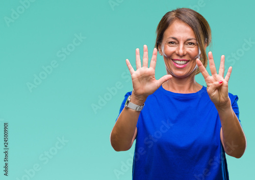 Middle age senior hispanic woman over isolated background showing and pointing up with fingers number nine while smiling confident and happy.