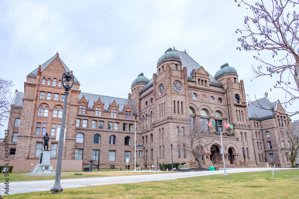 Fototapeta premium Scenic view of Legislative Assembly of Ontario in Toronto. Beautiful winter look of ancient historic building in center of largest megapolis of Ontario province and Canada