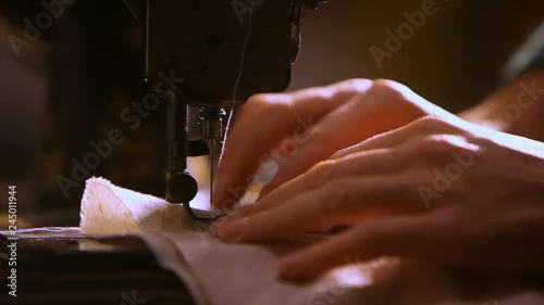 women's hands close-up at the sewing machine.sewing handmade clothes