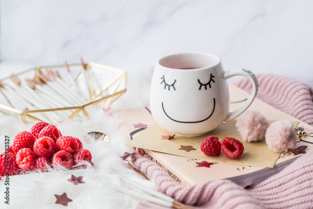 Cup of freshly brewed fruit and herbal tea, fresh raspberry, cookies, book, clothes. Photo for fashion, lifestyle and food blogs, content Cup of freshly brewed fruit and herbal tea, fresh raspberry, cookies, book, clothes. Photo for fashion, lifestyle and food blogs, content