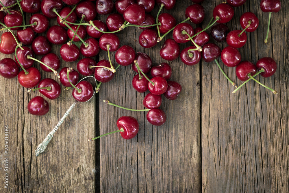 Freshly picked cherries on rustic wooden desk background. Freshly picked cherries on rustic wooden desk background.