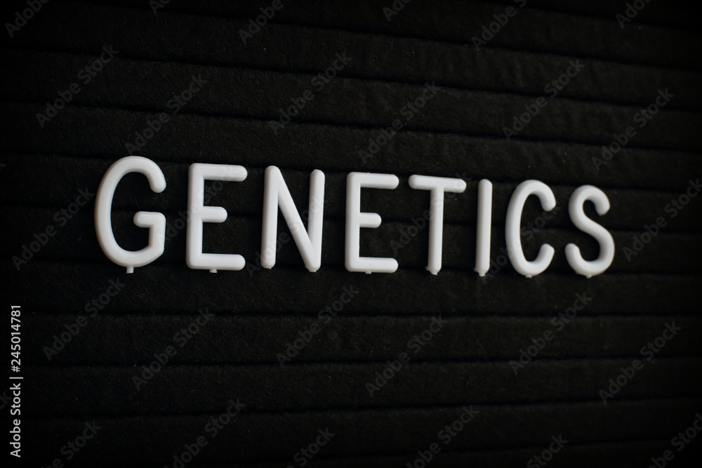 The word Genetics in white plastic letters on a black letter board 