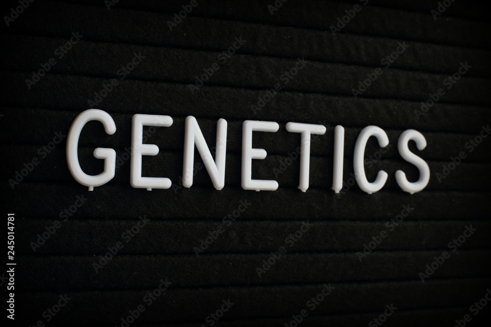 The word Genetics in white plastic letters on a black letter board The word Genetics in white plastic letters on a black letter board