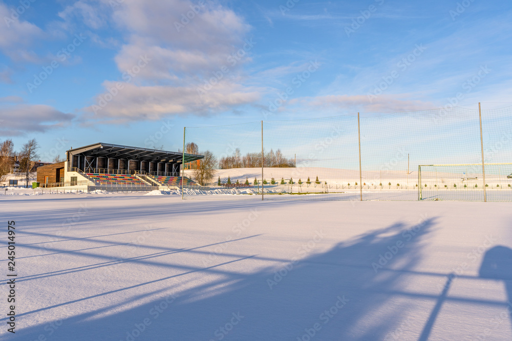 Empty Football (Soccer) Field in the Winter Partly Covered in Snow - Sunny Winter Day