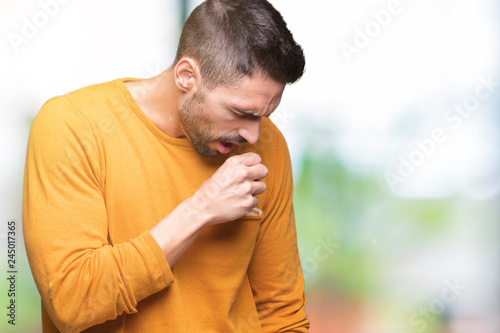 Young handsome man over isolated background feeling unwell and coughing as symptom for cold or bronchitis. Healthcare concept.
