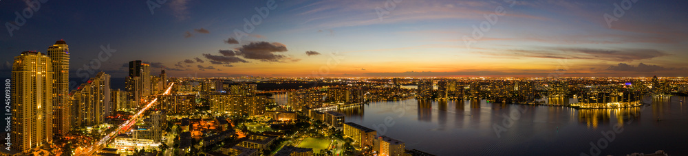 Aerial twilight photo Miami Sunny Isles Beach illuminated glowing city