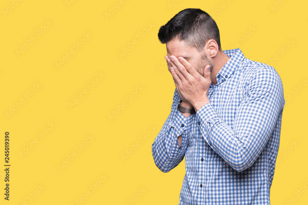 Young handsome man over isolated background with sad expression covering face with hands while crying. Depression concept. Young handsome man over isolated background with sad expression covering face with hands while crying. Depression concept.
