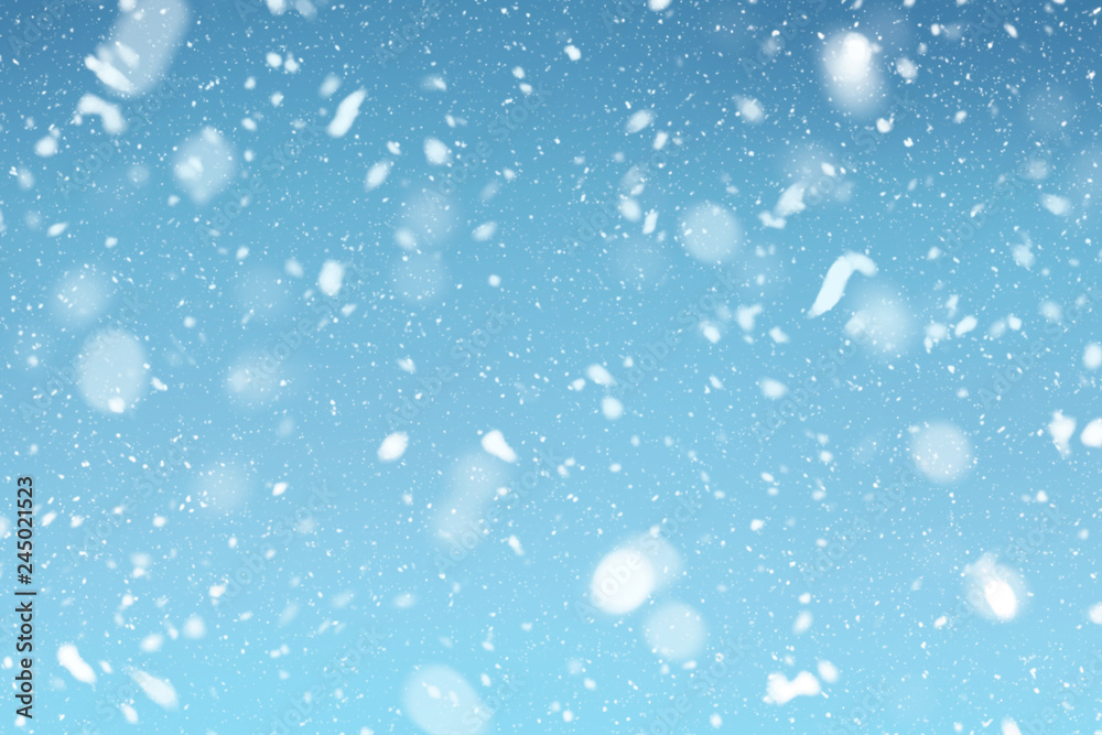 Snow falls on winter blue sky background Snow falls on winter blue sky background